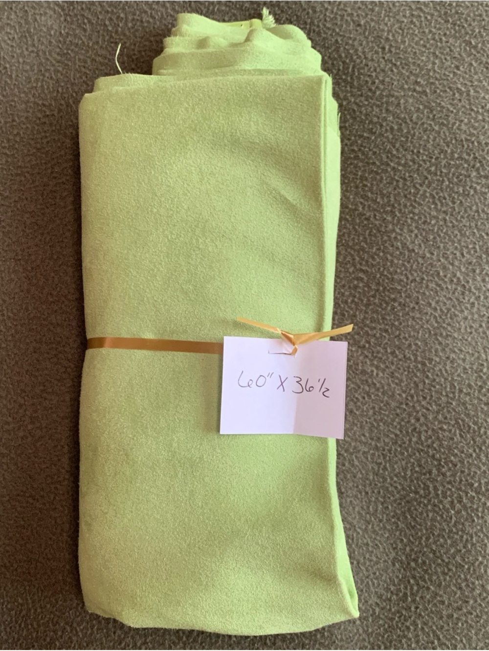 New green suede-like fabric remnant. Size approximately 60” x 36.5”